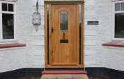 25. Hunter style solid oak door with a curved head and a large leaded/obscure glass. Frame with two sidelights. Door only (inc leaded domed window) £ 1200+vat, Std Frame £525+vat,